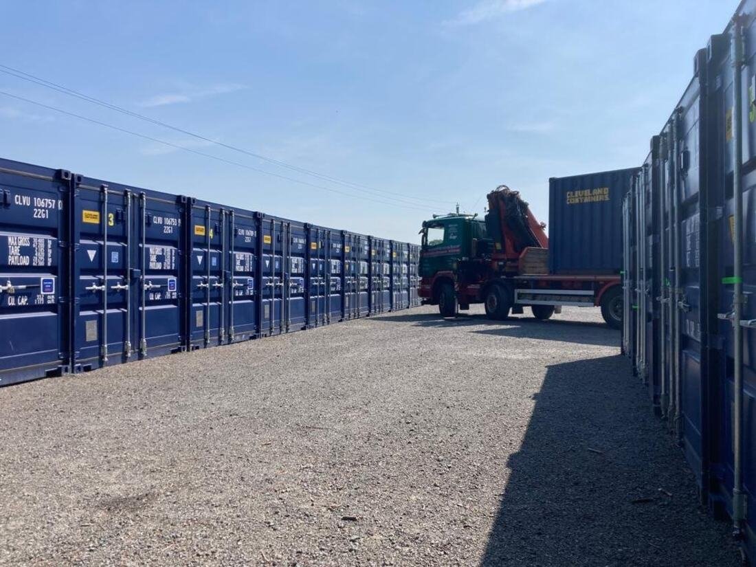 Storage containers at Penrhos Farm with the Herefordshire hills behind